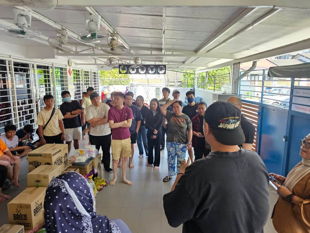 Cartons of donated diapers, detergent and food supplies stacked in the hall of the PKKII Insan home during the MedicalMet CSR charity visit in Kuala Lumpur