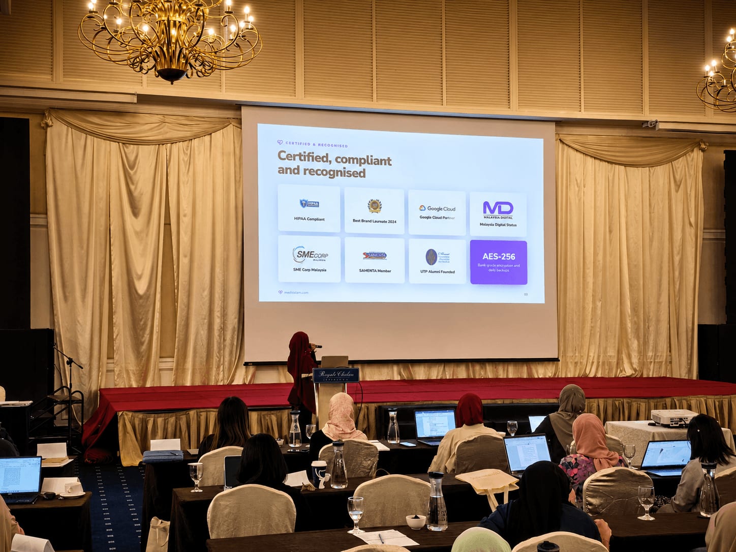 MedicalMet certifications slide at the UniKlinik Incubator 2026 showing HIPAA compliance, Google Cloud Partner, Malaysia Digital status and AES-256 encryption — MedicalMet